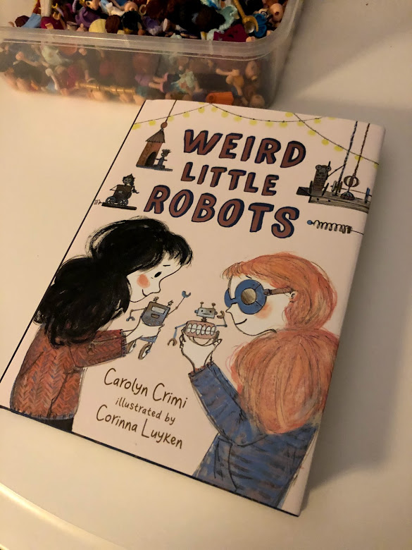 Weird Little Robots - Cover (plus my daughter’s collection of dismembered lego minifigs)